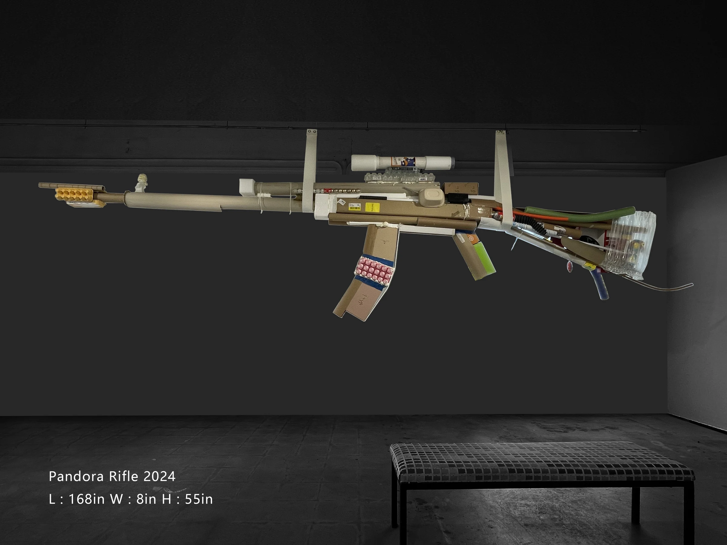 Pandora Rifle installed horizontally on a dark gallery wall