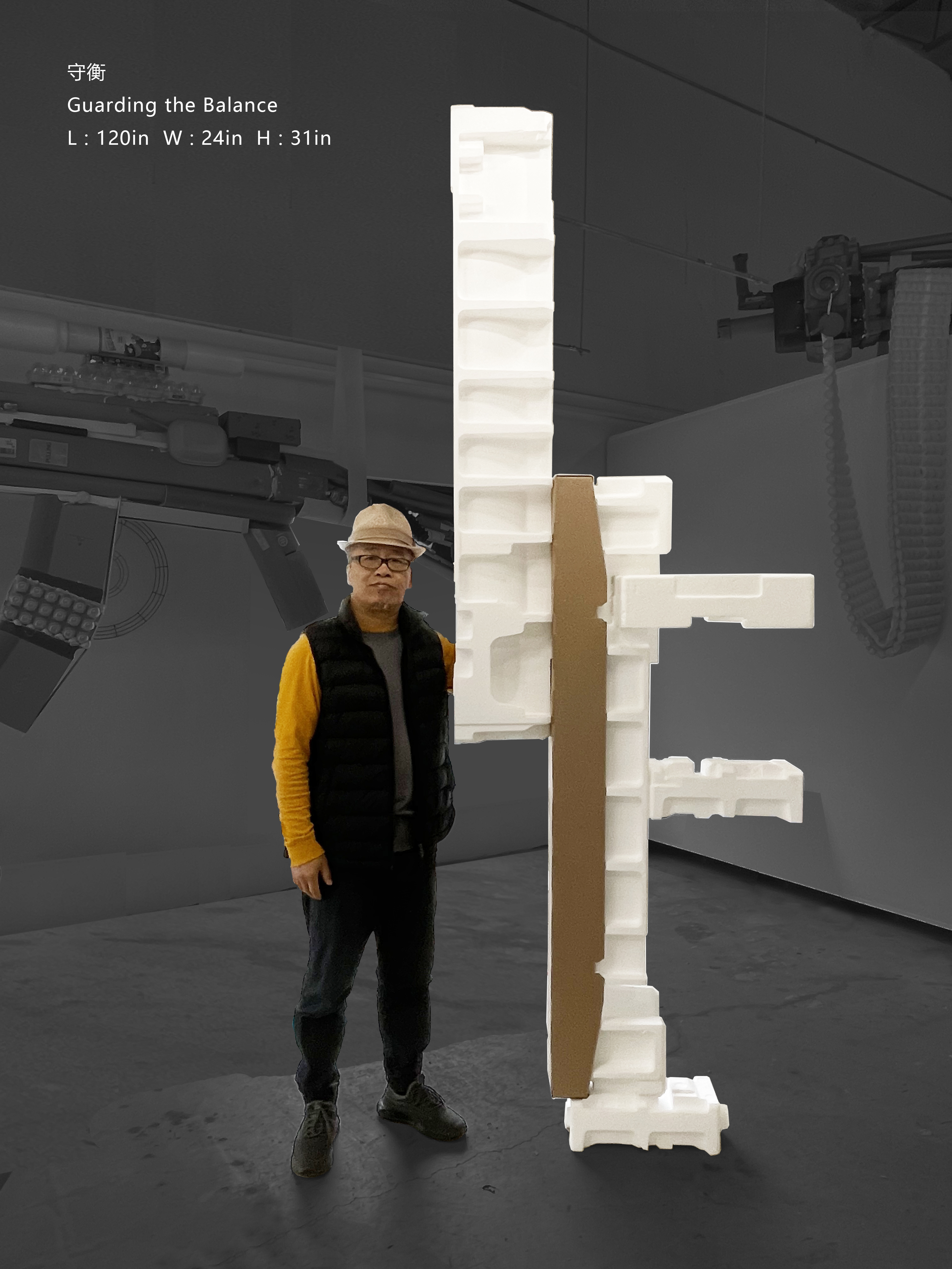 Zhongguo Zheng standing beside a tall white sculpture assembled from discarded foam packaging and cardboard